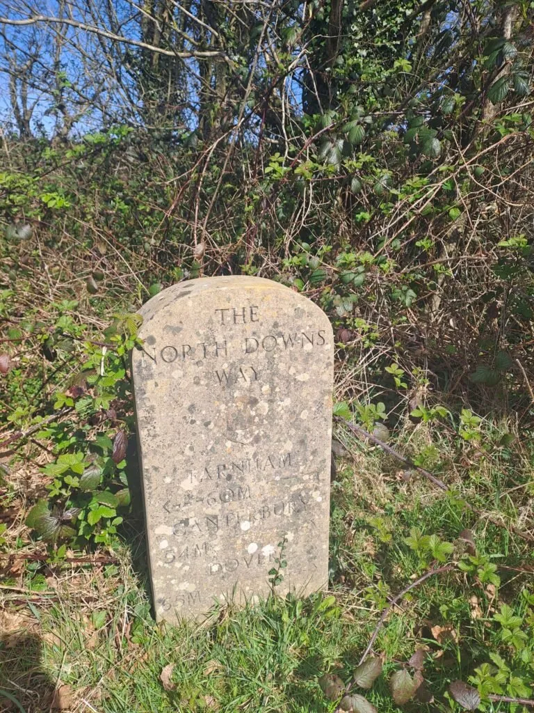 Distance marker on the North Downs Way showing 60 miles from Farnham